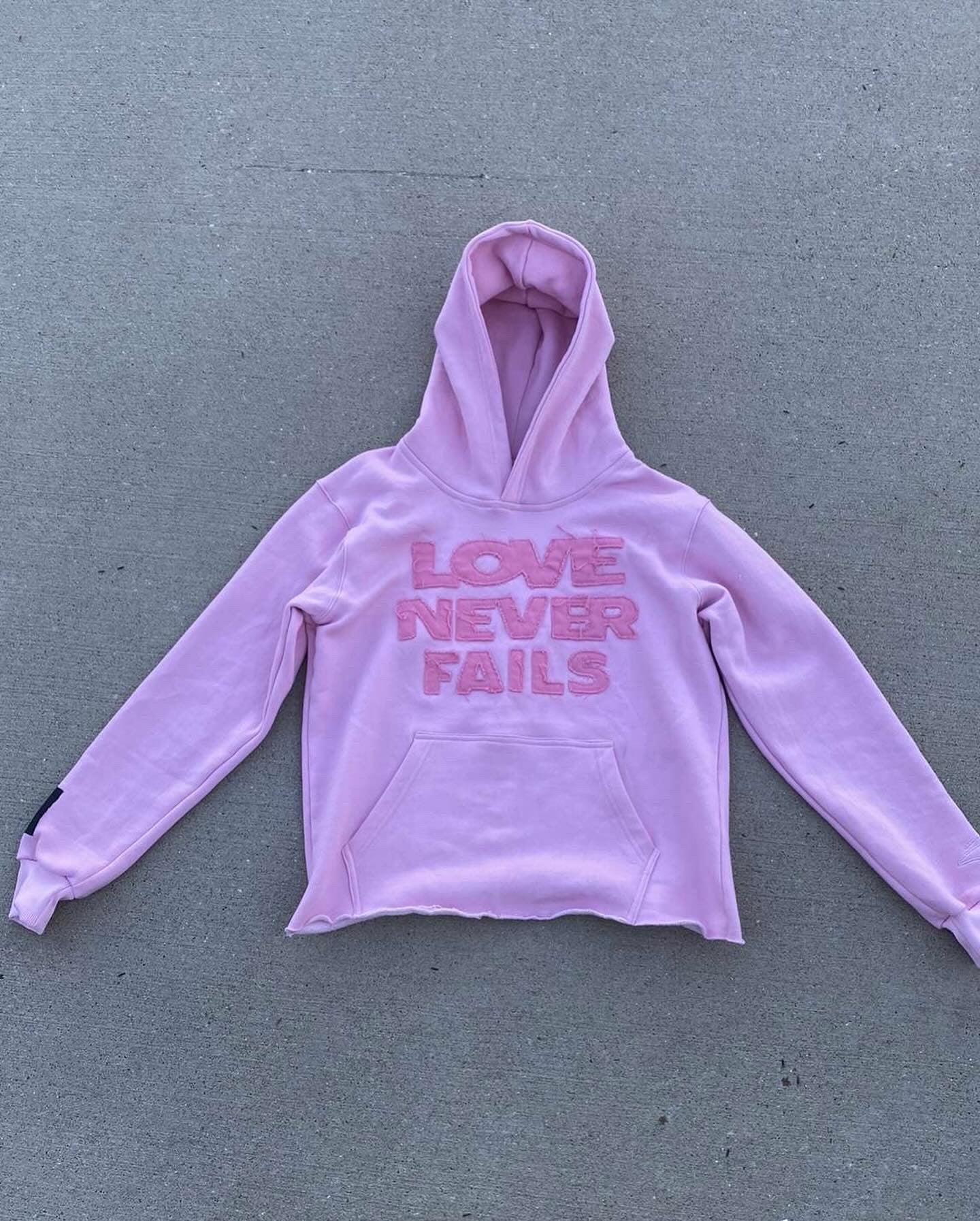 "Love Never Fails" Pink Hoodie